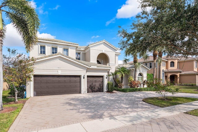 mediterranean / spanish-style house with a garage