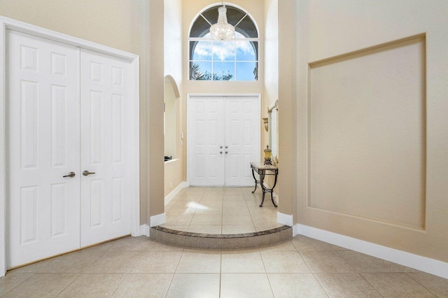 tiled foyer featuring a high ceiling