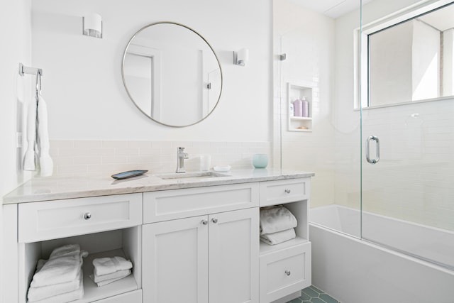 bathroom featuring vanity and shower / bath combination with glass door