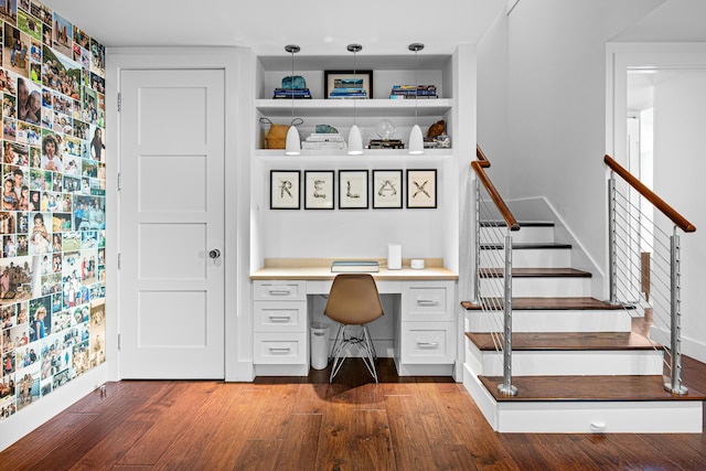 office area featuring built in desk and hardwood / wood-style flooring