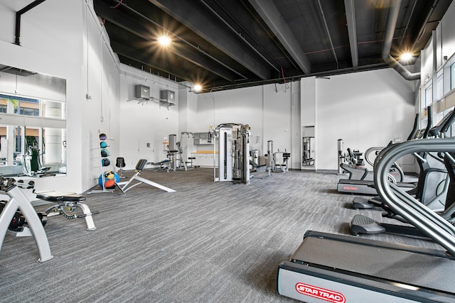 gym with a towering ceiling