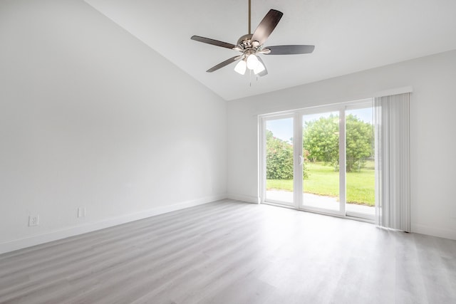 empty room featuring ceiling fan, light wood-type flooring, and vaulted ceiling