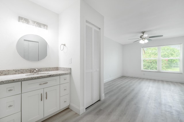 bathroom with hardwood / wood-style floors, vanity, and ceiling fan