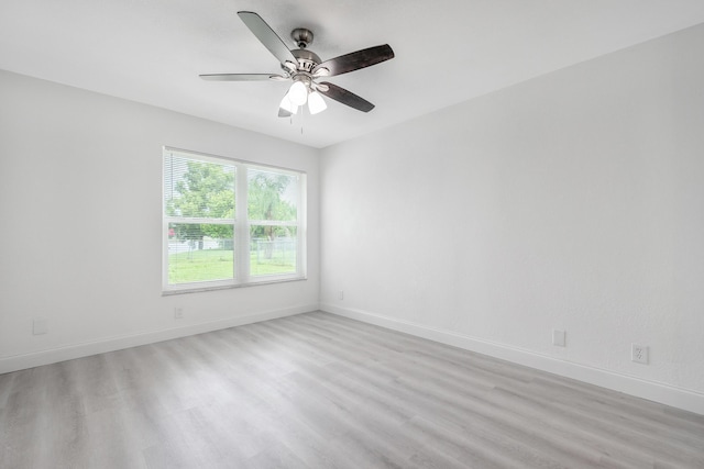 empty room featuring light wood-type flooring and ceiling fan