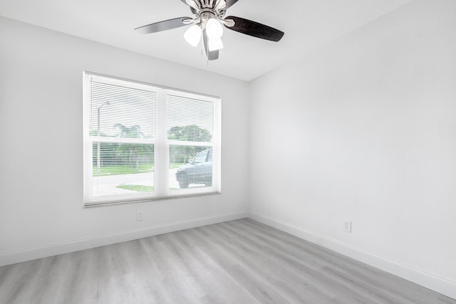 empty room with ceiling fan and light hardwood / wood-style floors