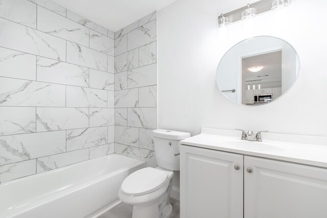 full bathroom with toilet, tiled shower / bath combo, and vanity