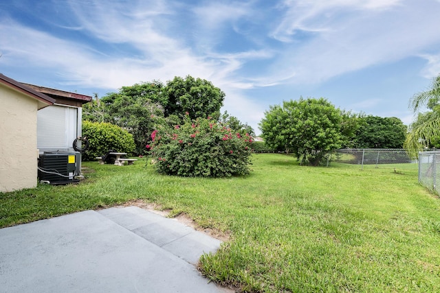 view of yard with central AC and a patio area