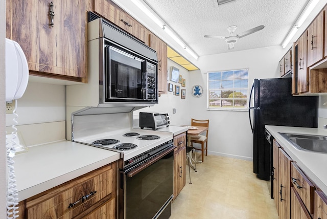 kitchen with a textured ceiling, ceiling fan, sink, and black appliances