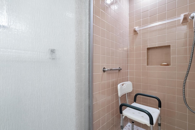 bathroom featuring a shower with door