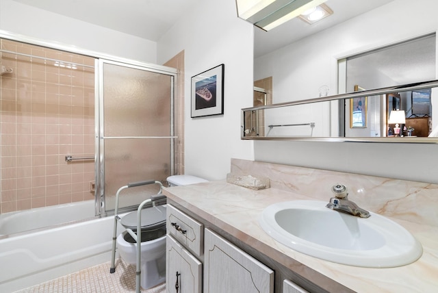 full bathroom featuring toilet, tile patterned floors, vanity, and enclosed tub / shower combo