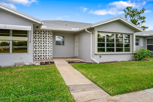 property entrance with a yard