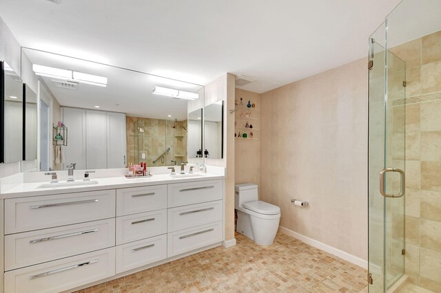 bathroom with toilet, walk in shower, and vanity