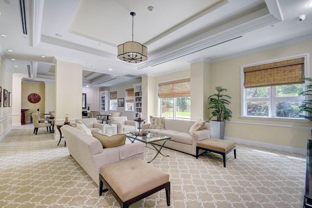 living room featuring light carpet, a tray ceiling, and crown molding