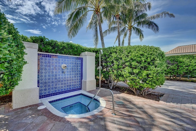 view of pool featuring an in ground hot tub