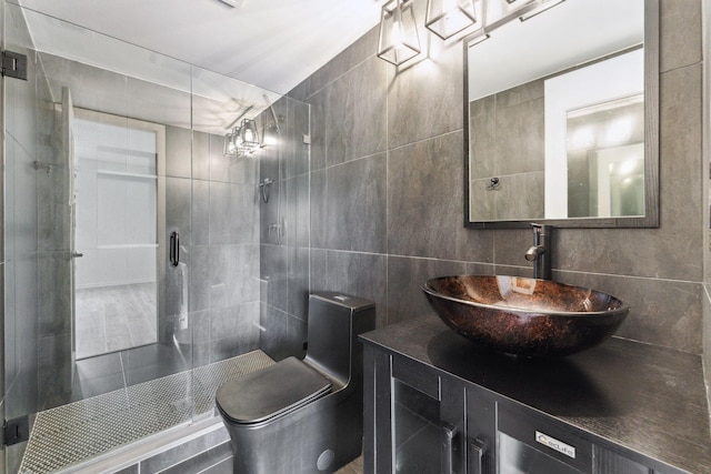 bathroom featuring tile walls, toilet, walk in shower, and vanity