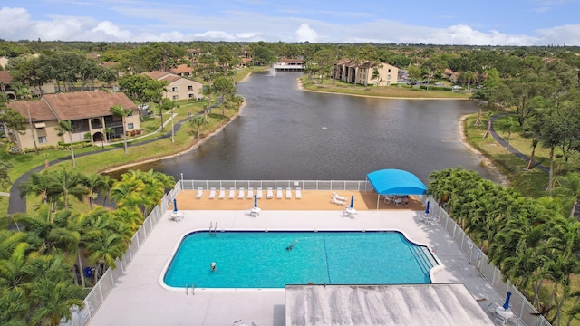 view of pool featuring a water view and a patio area