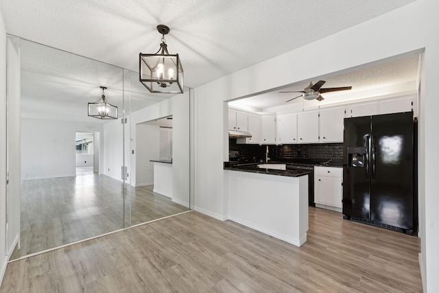 kitchen featuring black fridge with ice dispenser, white cabinetry, ceiling fan, backsplash, and pendant lighting