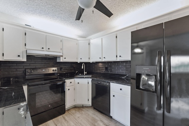 kitchen with sink, light hardwood / wood-style floors, white cabinetry, and black appliances