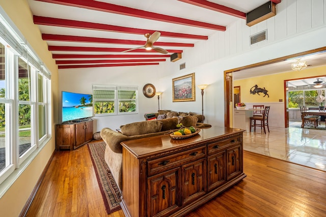 living room with ceiling fan with notable chandelier, light hardwood / wood-style floors, and plenty of natural light