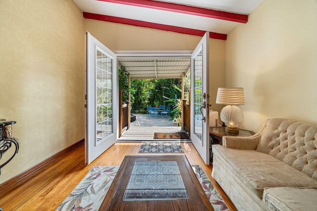 doorway to outside featuring hardwood / wood-style flooring, vaulted ceiling with beams, and french doors