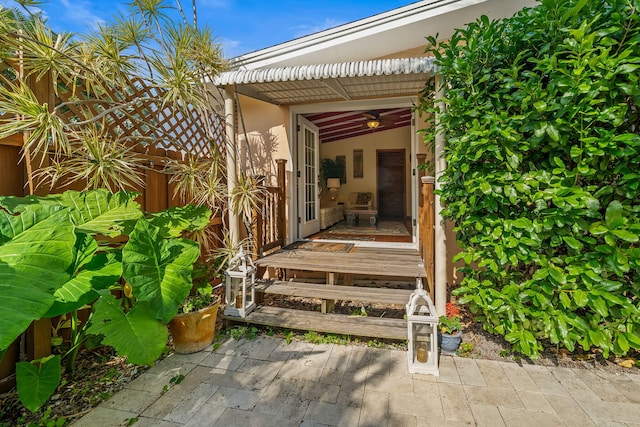 view of exterior entry featuring a patio area