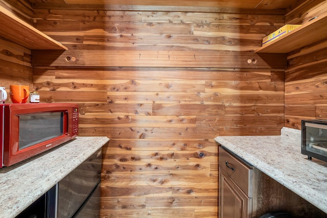 bar with wooden walls and light stone countertops