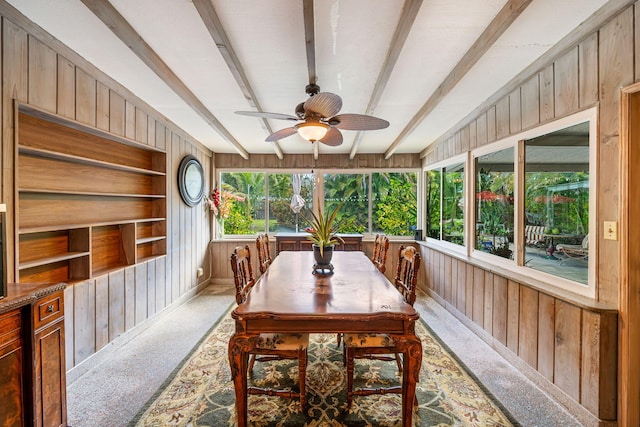 sunroom featuring beamed ceiling and ceiling fan