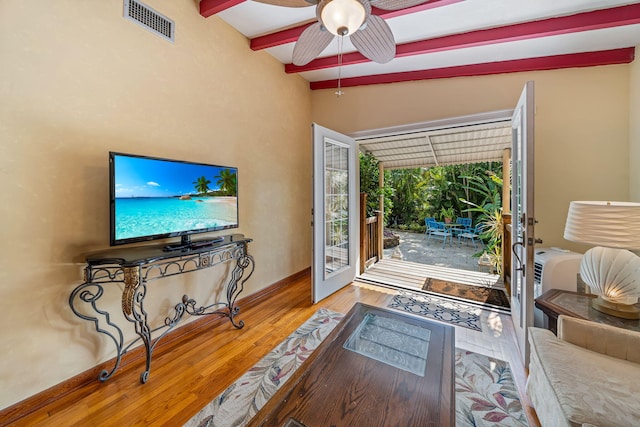 interior space featuring ceiling fan, lofted ceiling with beams, french doors, and wood-type flooring