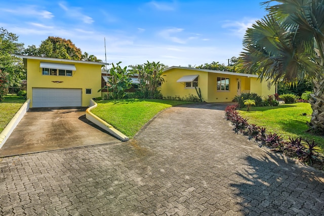 view of front of house featuring a garage and a front lawn