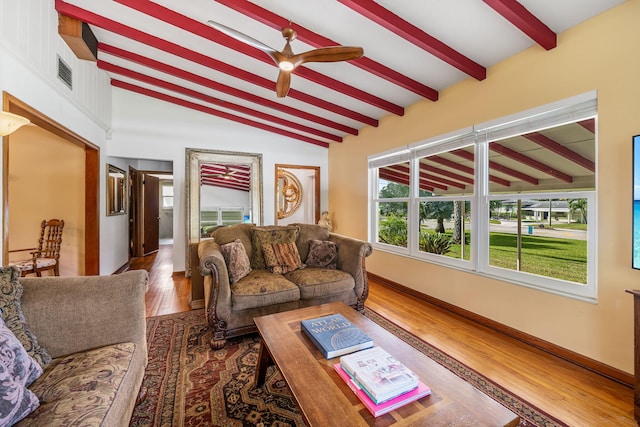 living room with dark hardwood / wood-style floors, vaulted ceiling with beams, and ceiling fan