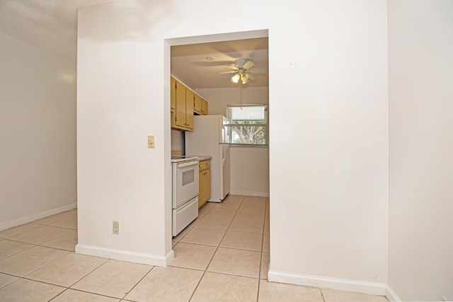 kitchen with ceiling fan, light tile patterned flooring, and white appliances