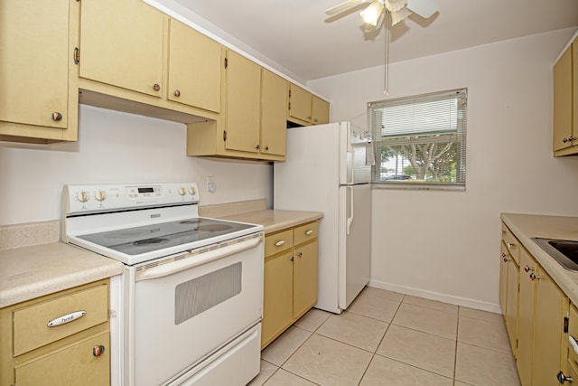 kitchen featuring ceiling fan, light tile patterned floors, sink, and white appliances