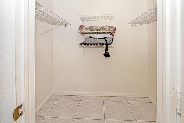 spacious closet featuring light tile patterned floors