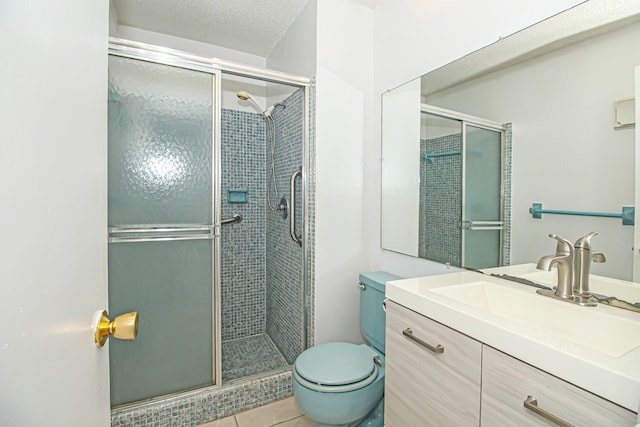 bathroom with toilet, tile patterned flooring, an enclosed shower, a textured ceiling, and vanity