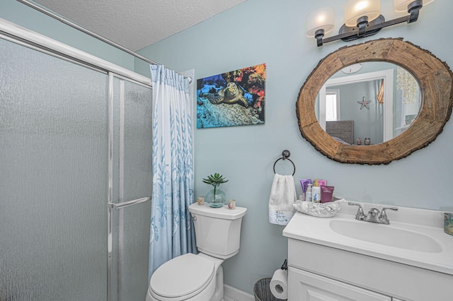 bathroom with toilet, a textured ceiling, walk in shower, and vanity