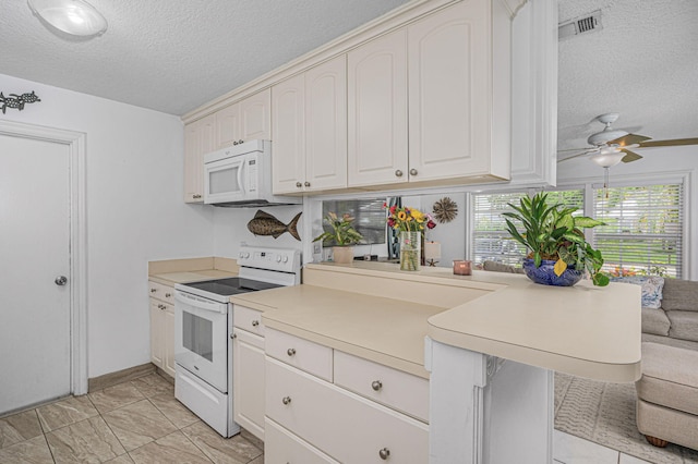 kitchen featuring white appliances, kitchen peninsula, ceiling fan, a textured ceiling, and white cabinetry