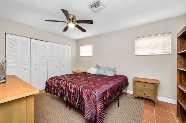 tiled bedroom with a closet and ceiling fan