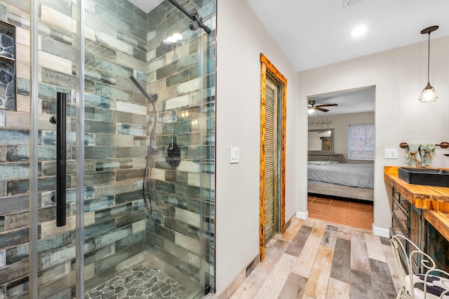 bathroom with a shower with door and ceiling fan