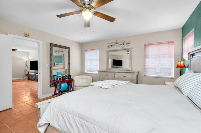 tiled bedroom with multiple windows and ceiling fan