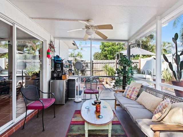 sunroom with a healthy amount of sunlight and ceiling fan