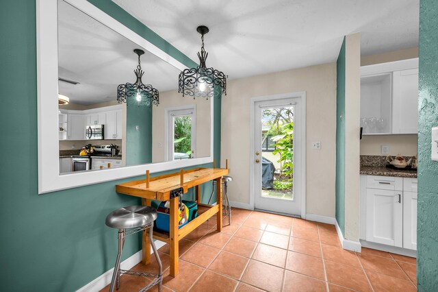 sunroom with ceiling fan and a healthy amount of sunlight