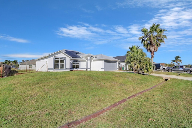 view of front of property with solar panels and a front yard