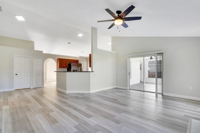 unfurnished living room featuring ceiling fan, light hardwood / wood-style flooring, and high vaulted ceiling