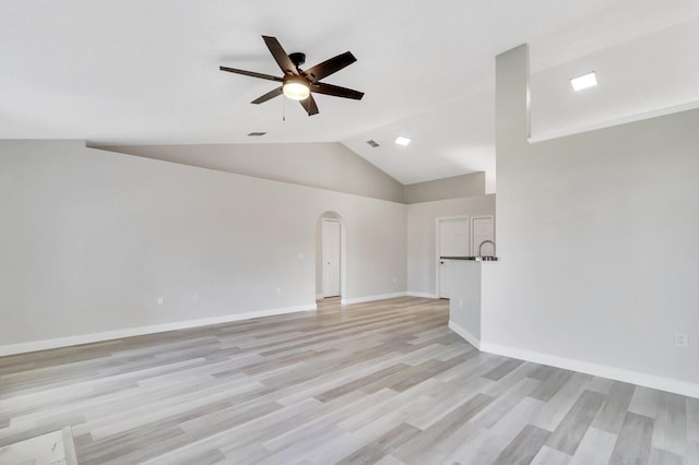 unfurnished living room with lofted ceiling, ceiling fan, and light hardwood / wood-style floors