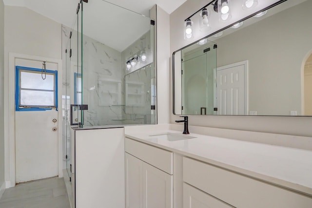 bathroom featuring walk in shower and vanity