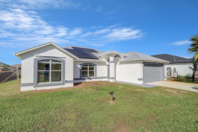 view of front facade featuring solar panels, a front yard, and a garage