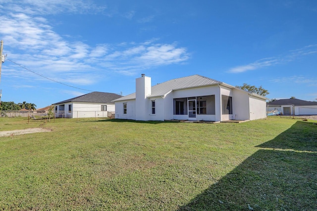 back of property featuring a yard