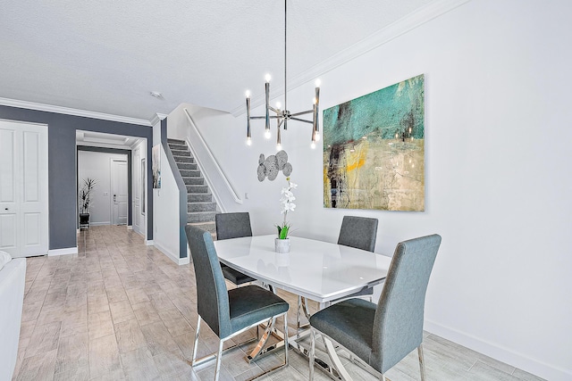 dining space with a notable chandelier, a textured ceiling, light hardwood / wood-style floors, and crown molding