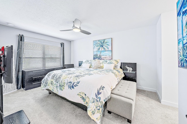 bedroom with a textured ceiling, ceiling fan, and carpet flooring