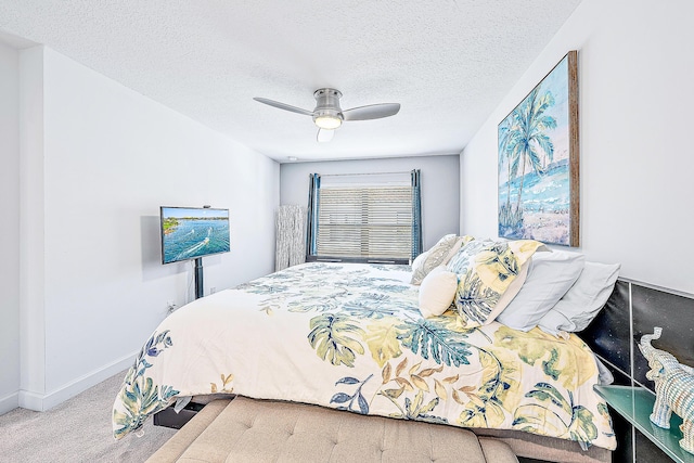 carpeted bedroom with a textured ceiling and ceiling fan